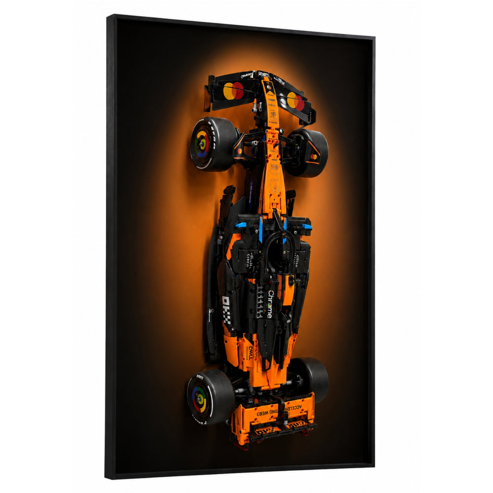 ONE MAAY Halo wall display frame for LEGO Technic 42228 McLaren F1 MCL39 — top-down view of papaya orange Formula 1 race car model on black framed panel