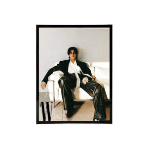 Black acrylic picture frame showing a person sitting on a couch wearing a black suit with a white shirt, framed with a black border.