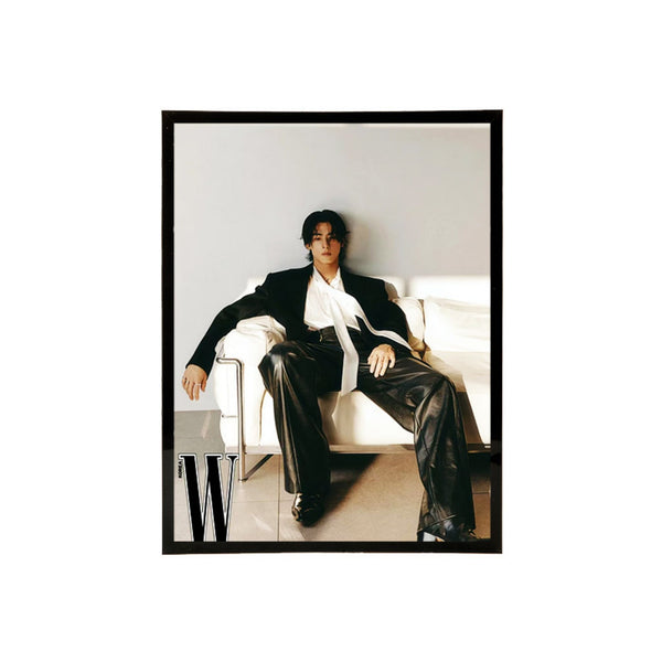 Black acrylic picture frame showing a person sitting on a couch wearing a black suit with a white shirt, framed with a black border.