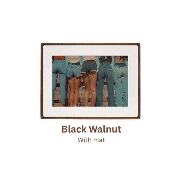 Black walnut picture frame with a cutout of people wearing teal overalls on a white background. With mat.