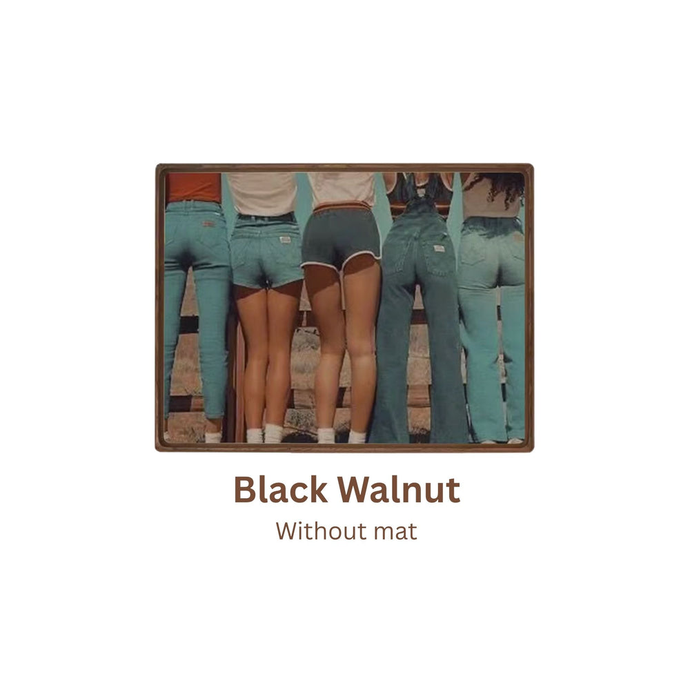 Black walnut picture frame with a cutout of people wearing teal overalls on a white background. Without mat.