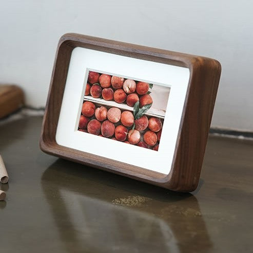 Framed black walnut picture of a person  in a cactus field on a white background