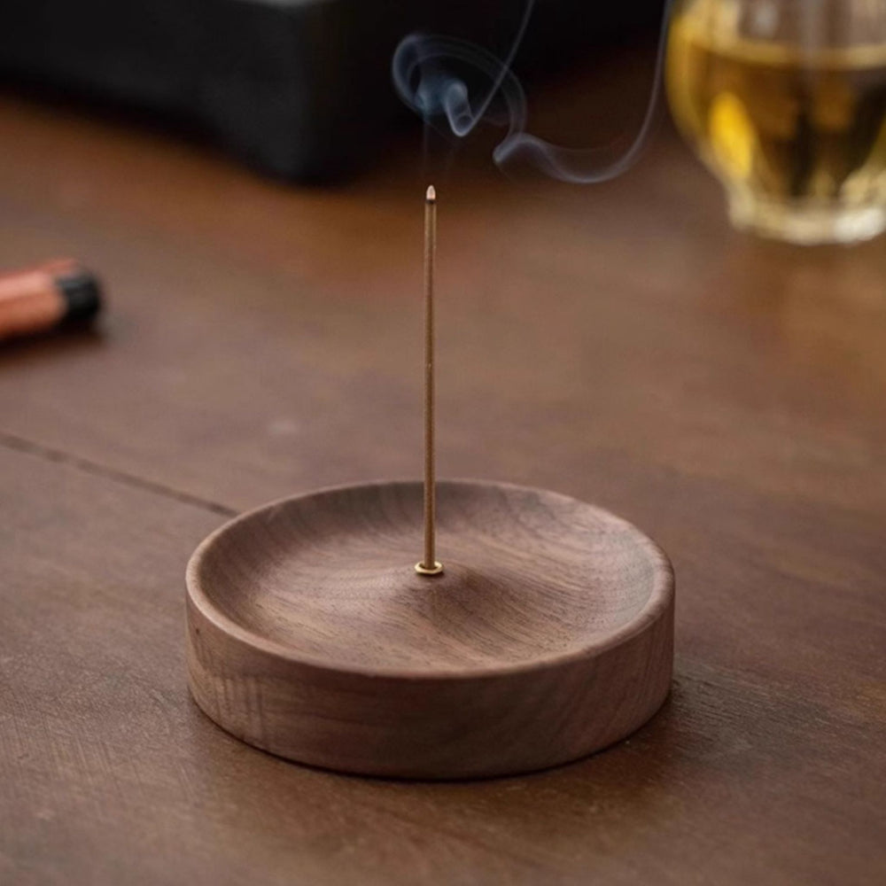 black walnut wood incense holder with a single incense stick on a white background