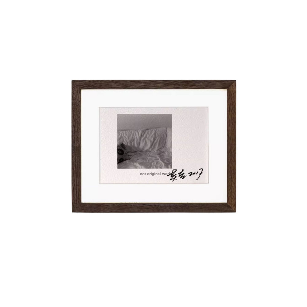 Black walnut wood framed black and white photograph with text on a white background