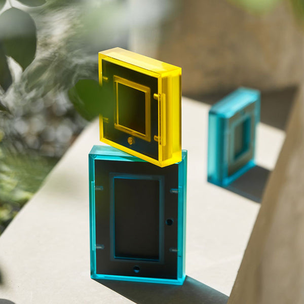 Three transparent picture frames with a blurred natural background