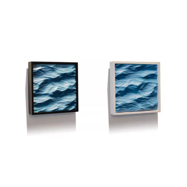 A black and white framed artworks depicting blue wave patterns on a white background