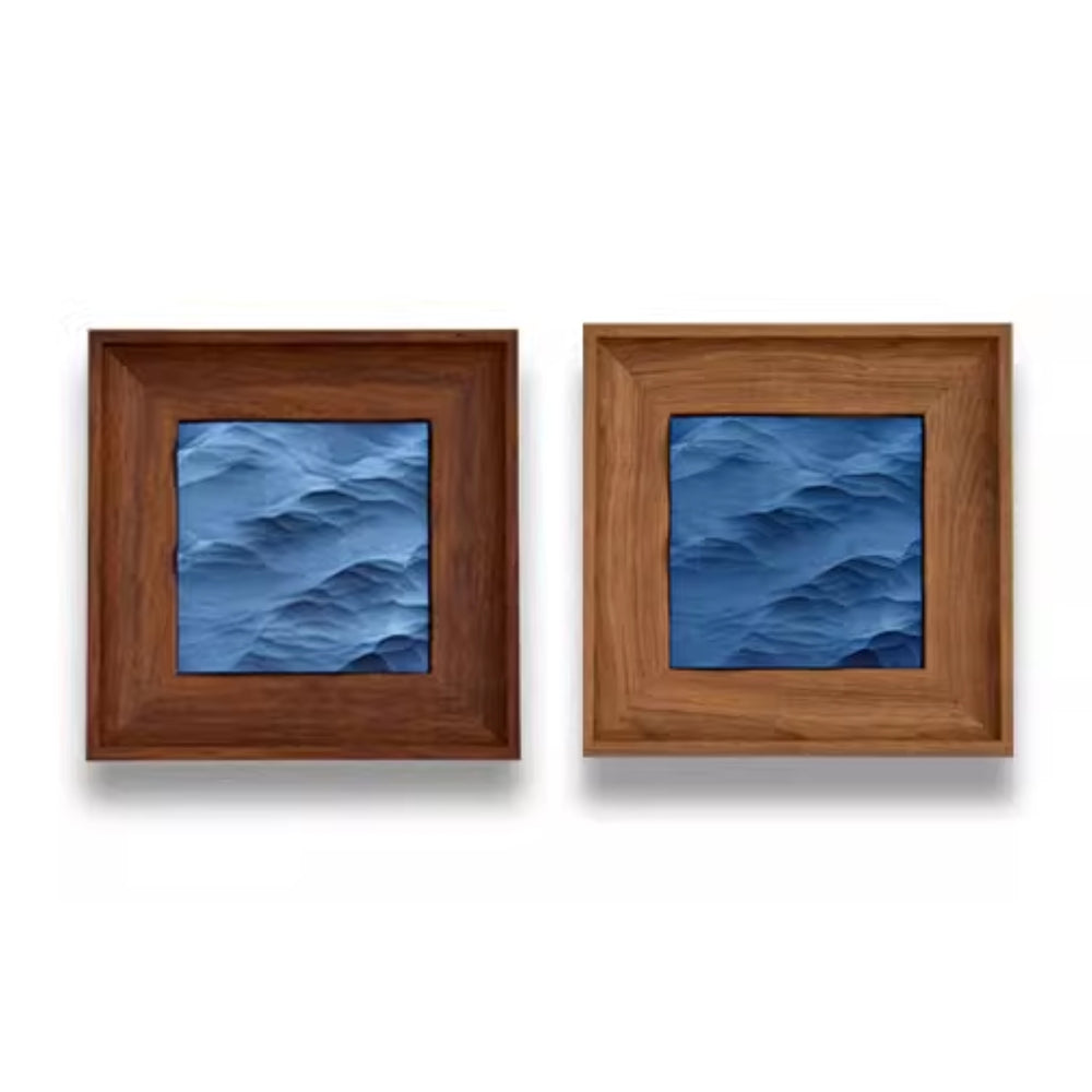 Two square framed artworks with blue wave patterns on a white background