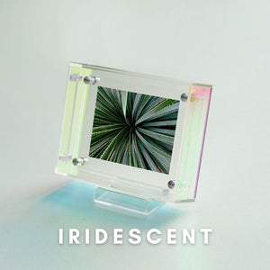 Iridescent acrylic picture frame with a starburst pattern on a light gradient background