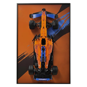 ONE MAAY Display frame, model of a Formula 1 LEGO 42141 car with a red, and yellow design on a dark orange wall display frame