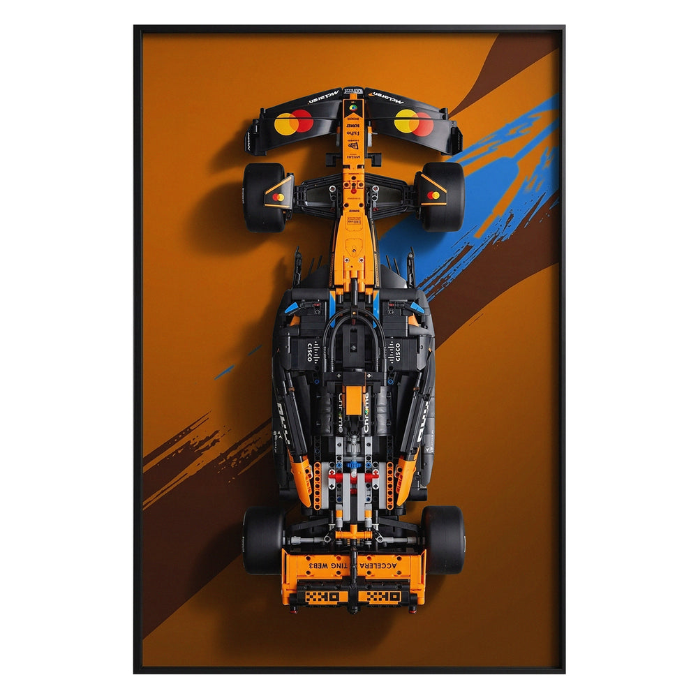 ONE MAAY Display frame, model of a Formula 1 LEGO 42228 car with a orange and brown paint design on a black wall display frame