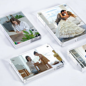 Four photos in magnetic acrylic picture frames displaying different images on a white background