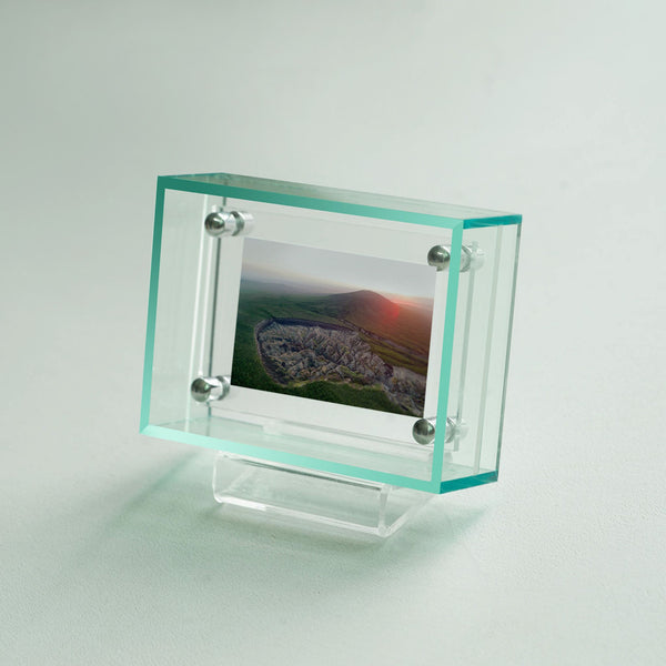 Acrylic light green mini picture frame with a scenic photograph on a light gray background. 