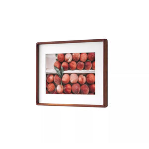 Merbau framed artwork of peaches on a white background, angled shot