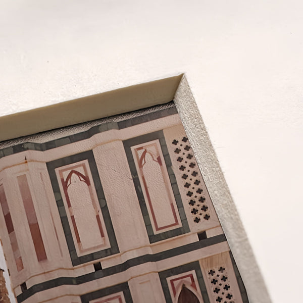 Close-up shot of a corner of the mat in the picture frame with a picture of decorative tile with geometric pattern.