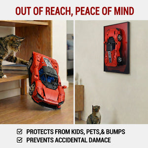 Red toy car LEGO 42143 on a wooden floor with a cat looking at it, and another car displayed on a ONE MAAY wall frame. Text 'Out of Reach, Peace of Mind' and product features.