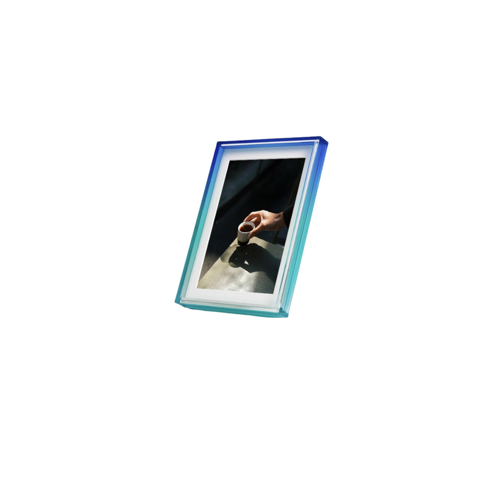 Ombre colour blue and green photo frame with a display showing a hand holding a coffee cup on a white background