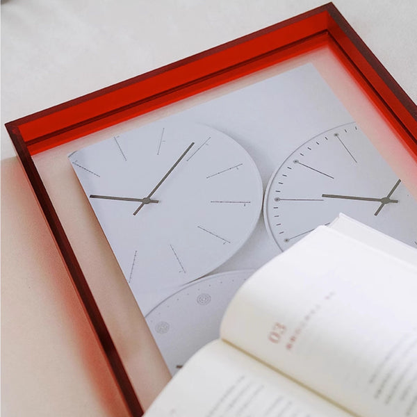 Red framed wall clock with red border on a white background