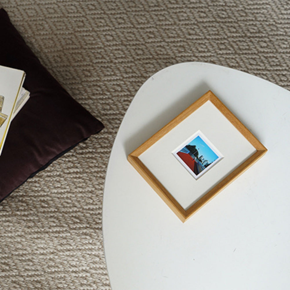 Framed picture of a dog in an autumn forest with a wooden frame. Teak beveled frame white background. 