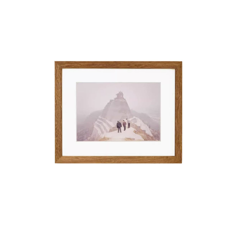 Teak wood framed photograph of two people walking on a mountain with a wooden frame.
