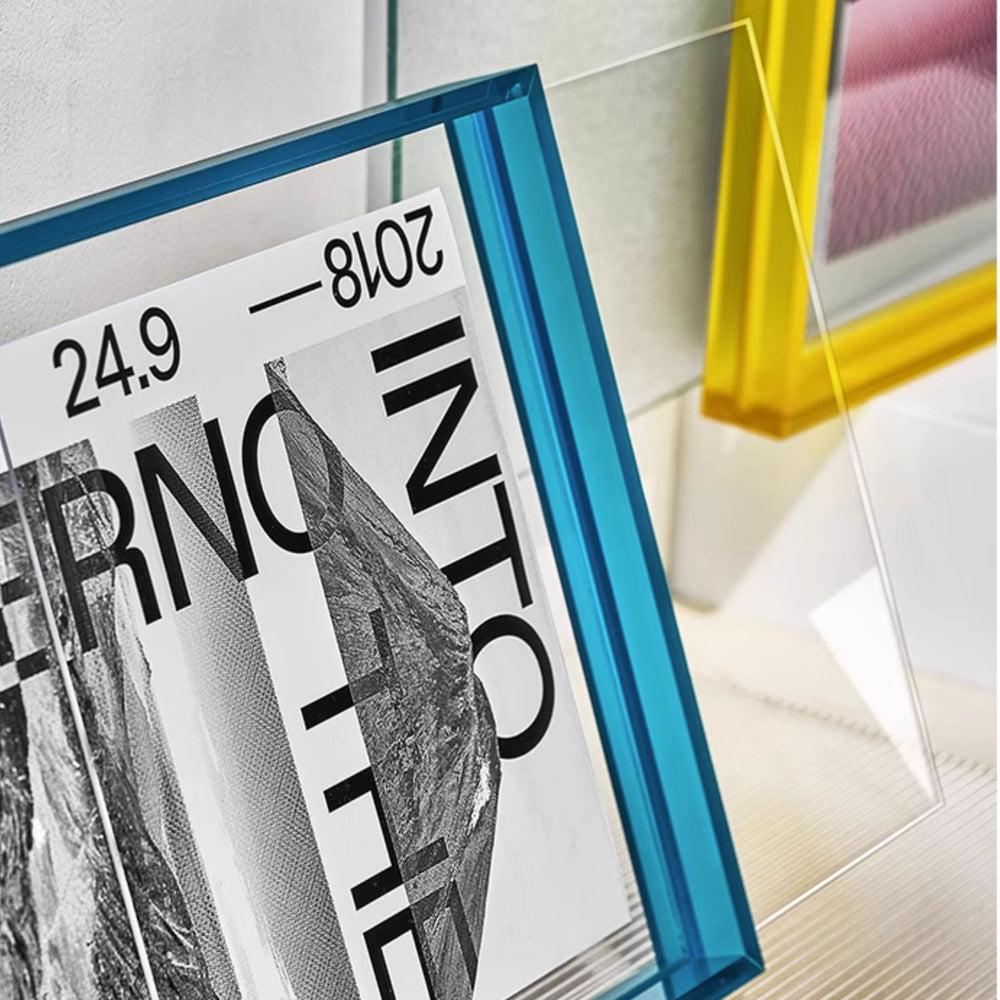 Blue thick large acrylic picture frames in a light gray background