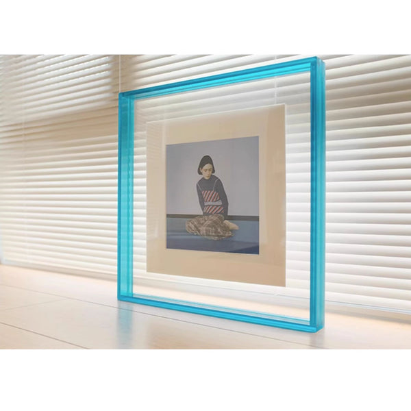 Blue picture framed artwork on a white surface