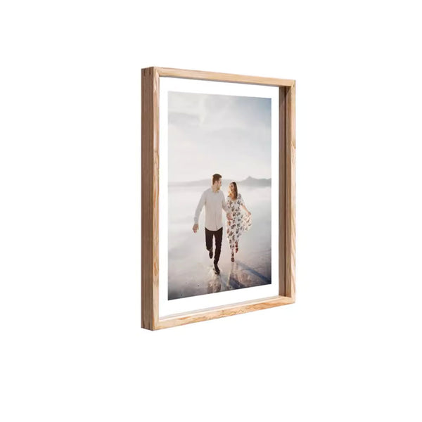 White ash wood picture frame with a photo of a couple on a beach with white background