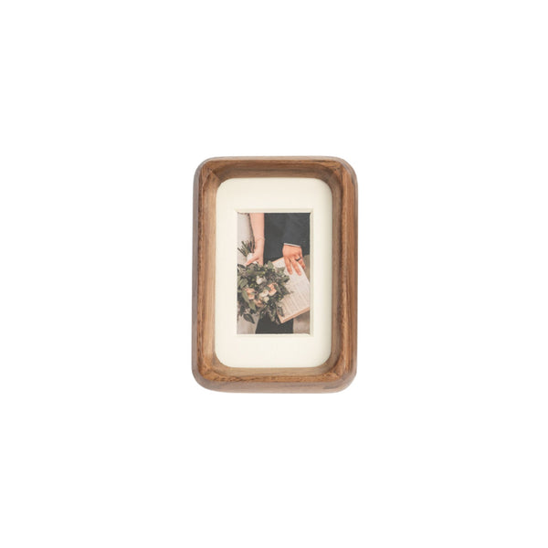Wooden black walnut photo frame with a small picture inside on a white mat - mini palm size
