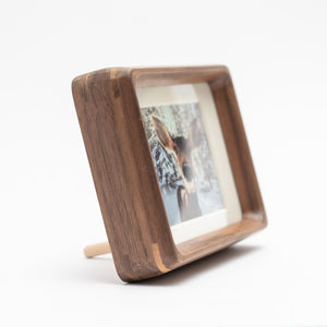 Black walnut photo frame with a graduation picture inside on a white background