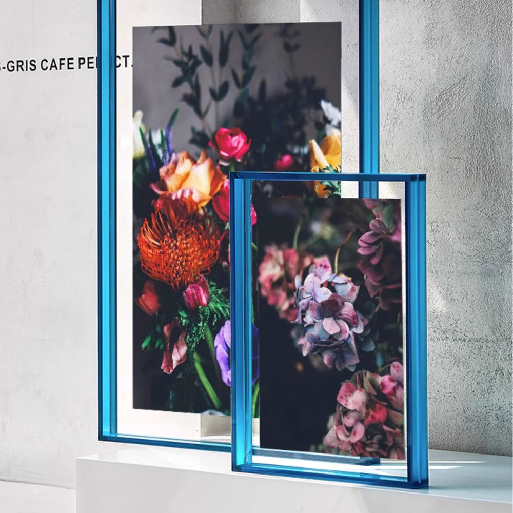 Blue thick large acrylic picture frames in a light gray background