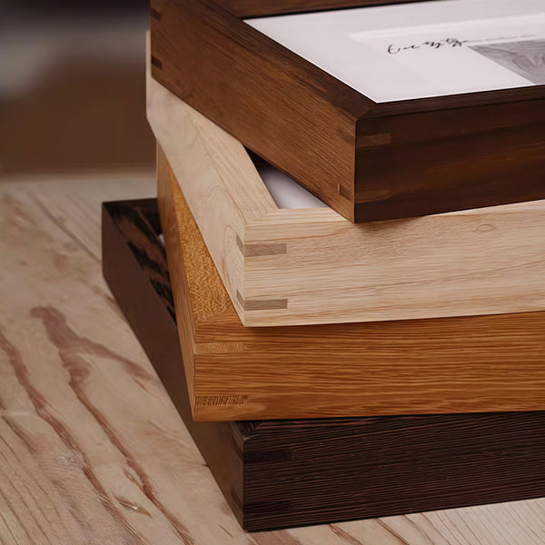 Close-up of wooden picture frames in various colors on the corner. Black Walnut, Wenge, White ashwood, Teak wood.