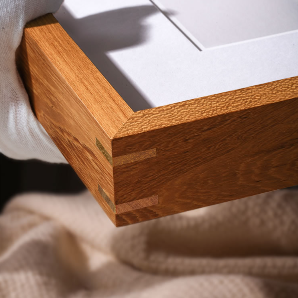Close-up of a wooden frame corner with a white background