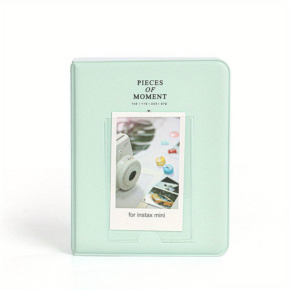 Mint green photo album for Instax mini with a small window displaying photos on a white background