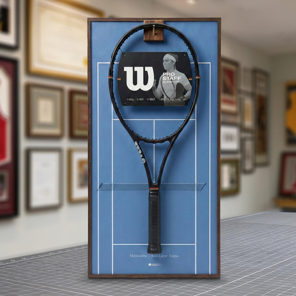 A ONE MAAY Australian Open-inspired blue hard court tennis racket wall display mounted elegantly next to a wooden bookshelf in a home library, featuring a dark blue side banner that reads "Australian Open"