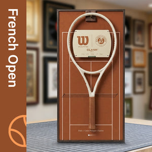A ONE MAAY French Open-inspired red clay court tennis racket wall display mounted elegantly next to a wooden bookshelf in a home library, featuring a brown side banner that reads "French Open"