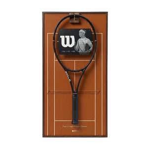 Front view of the ONE MAAY French Open-inspired tennis racket wall display, featuring a dark wood colored aluminum frame and a rich red clay court background holding a black tennis racket.