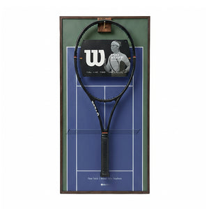 Front view of the ONE MAAY US Open-inspired tennis racket wall display, featuring a dark wood color aluminum frame and a vibrant blue hard court background holding a black tennis racket