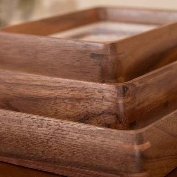 Close-up of a black walnut frames stacked with a blurred background