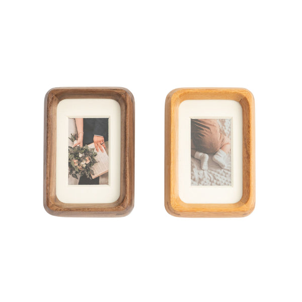 Two mini wooden picture frames with photos inside on a white background. Black walnut on the left, Teak wood on the right.