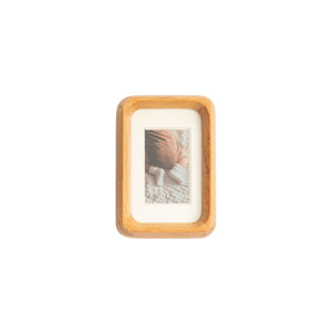 Wooden teak photo frame with a small picture inside on a white mat - mini palm size