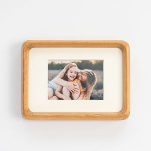 Wooden teak mini photo frame with a picture of a mother and daughter on a white background. Mother's Day special.