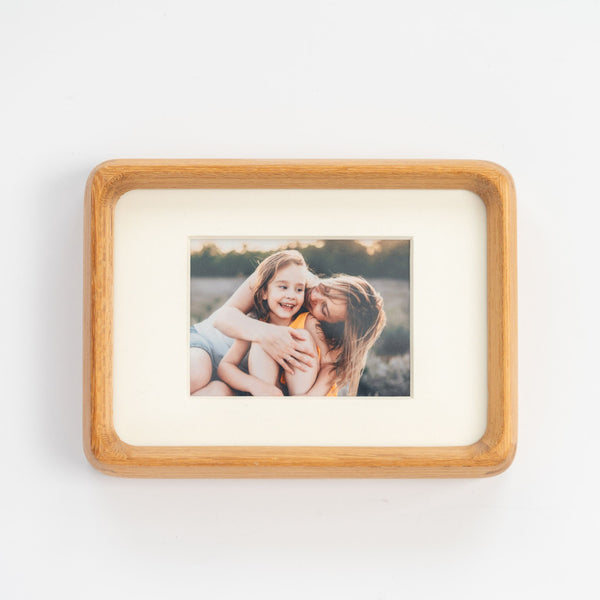 Wooden teak mini photo frame with a picture of a mother and daughter on a white background. Mother's Day special.