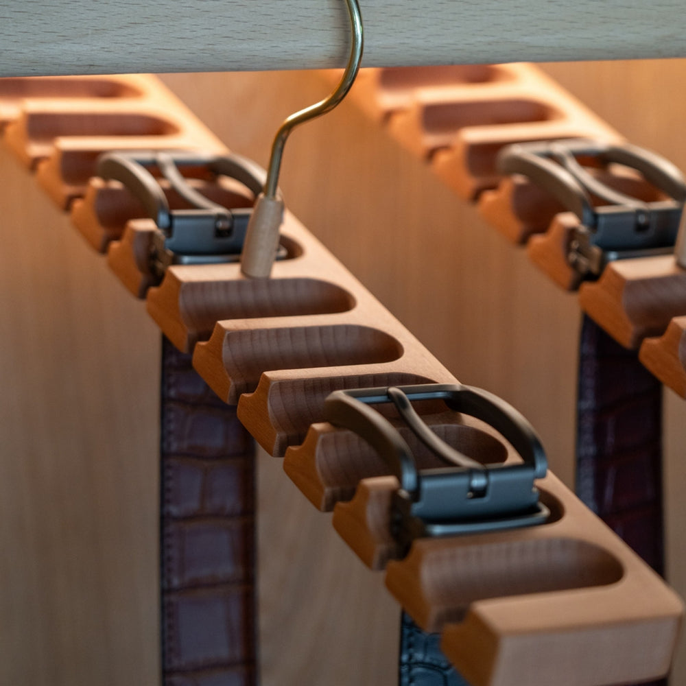 Wooden belt rack / belt hanger with a gold hook on a white background