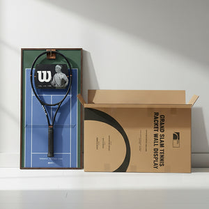 The US Open-themed ONE MAAY tennis racket wall display leaning against a white wall next to its open Grand Slam shipping box