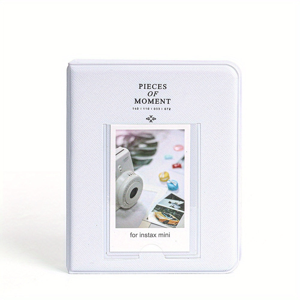 White photo album with 'Pieces of Moment' branding and a small window displaying a camera and photos.